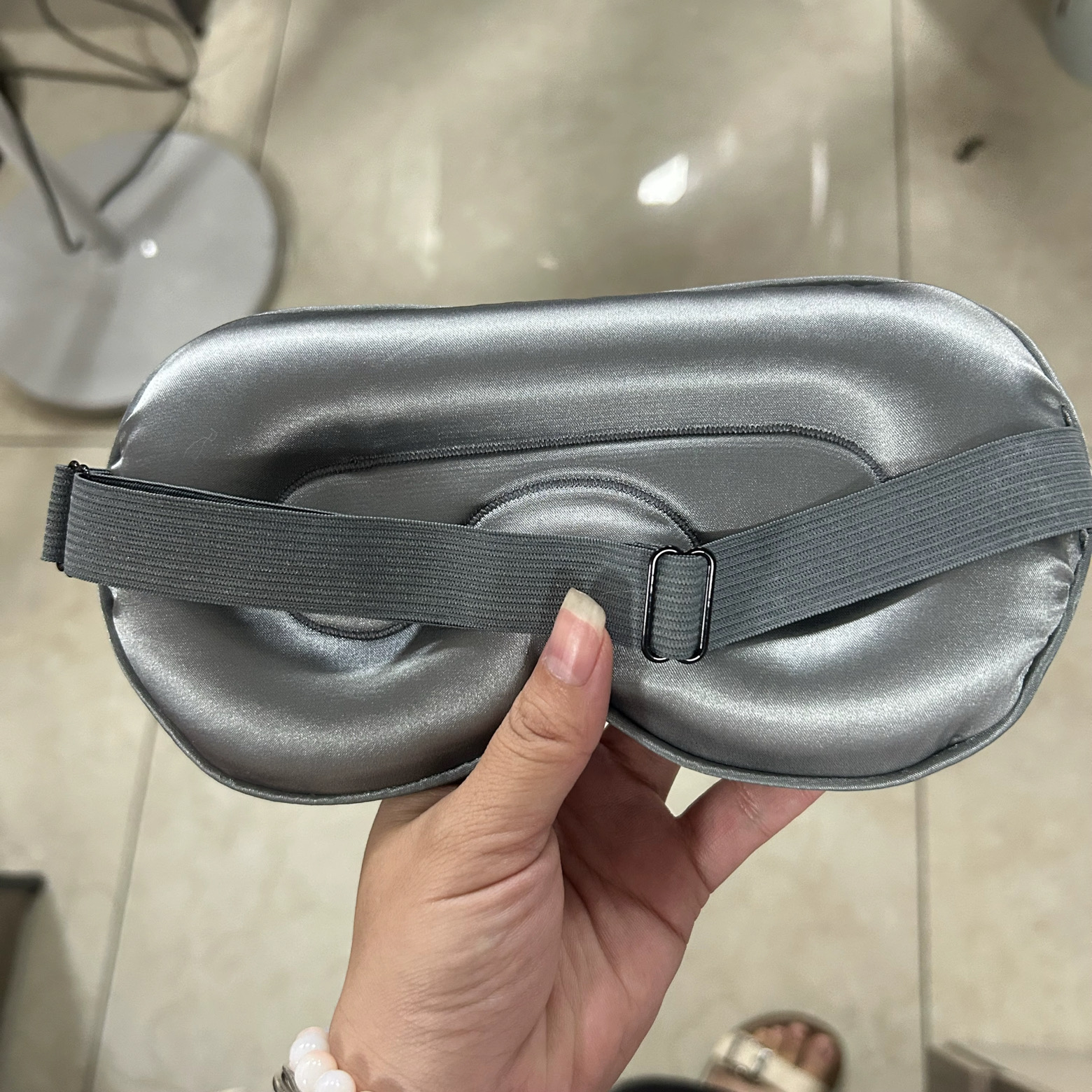Inside view of the contoured satin eye mask with raised eye cups and adjustable strap